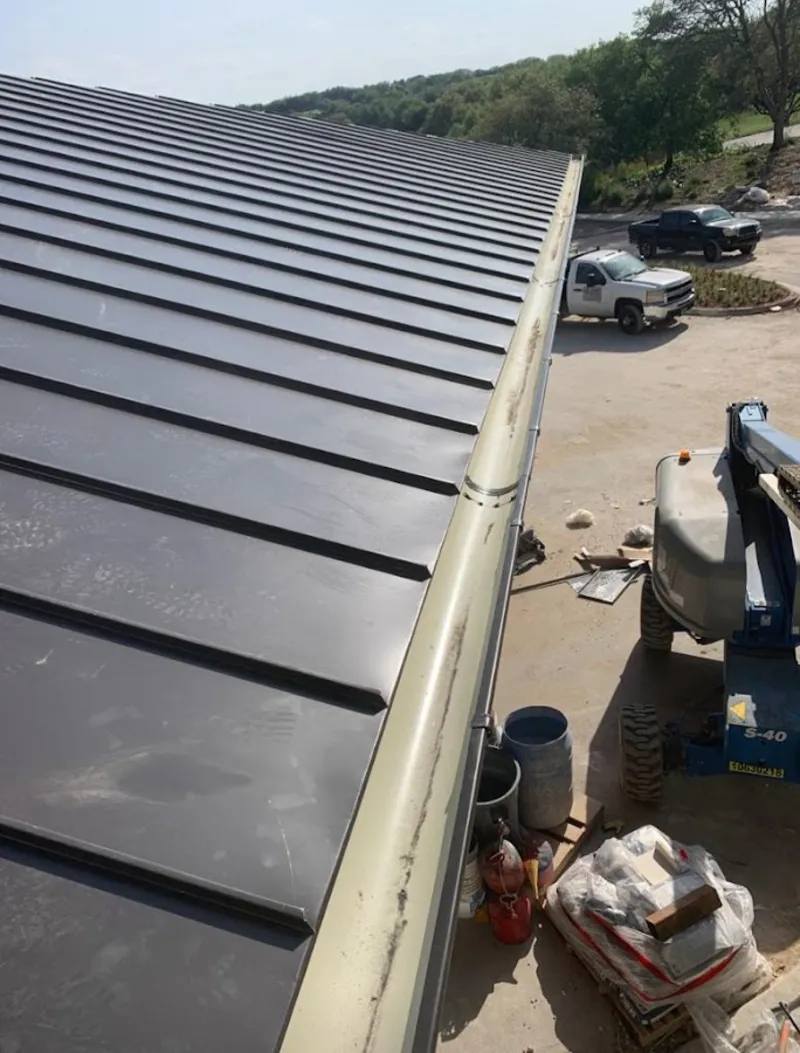 Standing seam panel and gutter detail on a metal roofing jobsite in Altoona